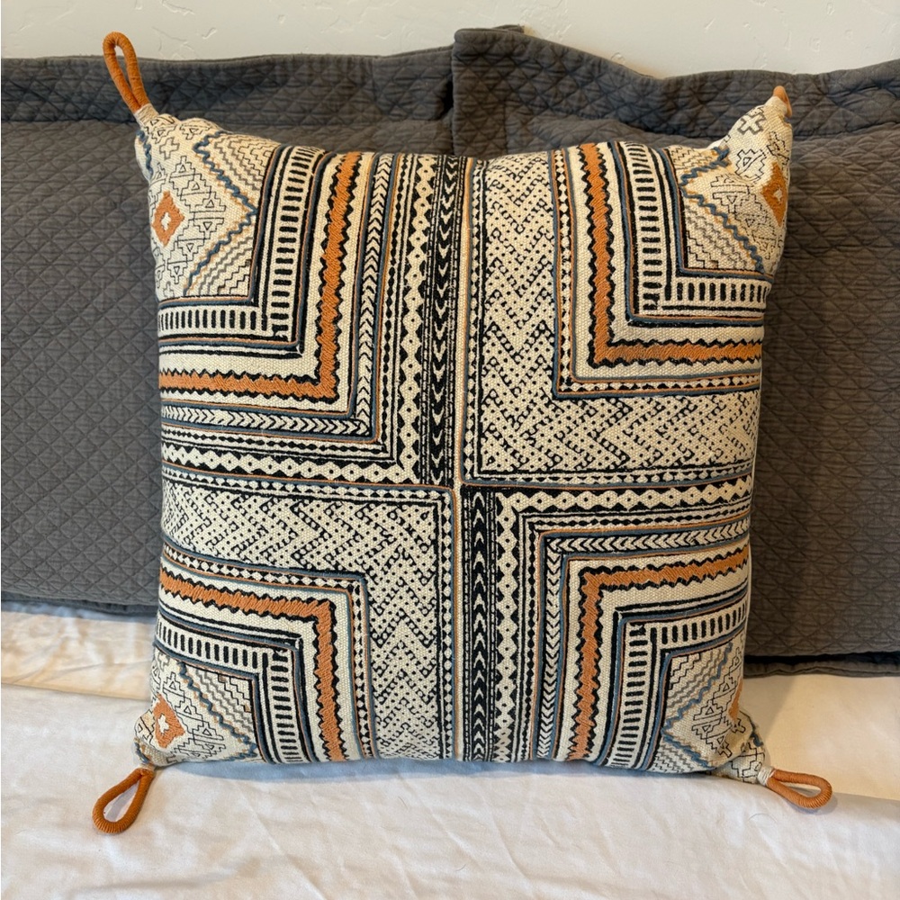 Geometric Patterned Pillow with Orange and Black Accents